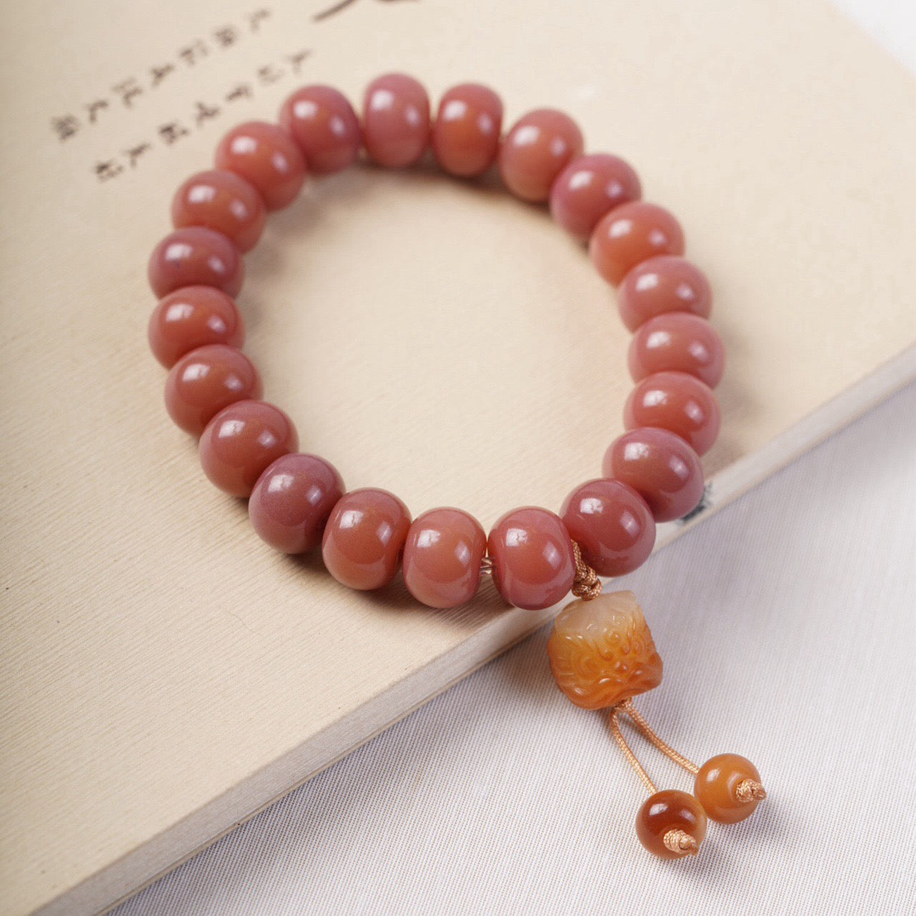 Smoky Pink Bodhi Bead Bracelet with Roaring Lion Pendant